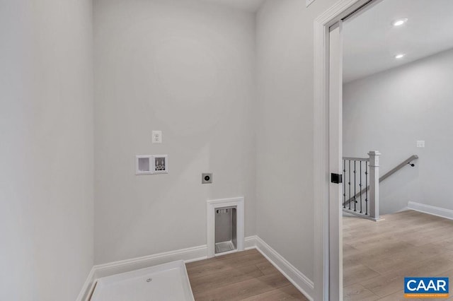 washroom featuring washer hookup, electric dryer hookup, and light wood-type flooring