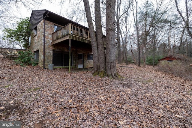 rear view of property featuring a wooden deck