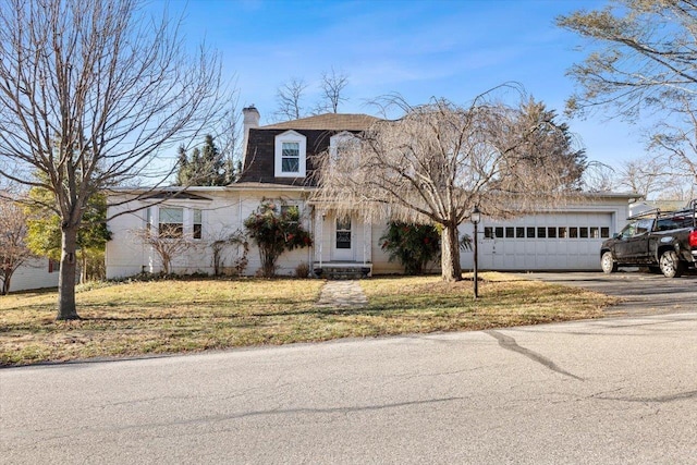 view of front of home with a garage and a front yard