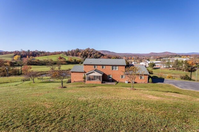 exterior space with a mountain view and a lawn