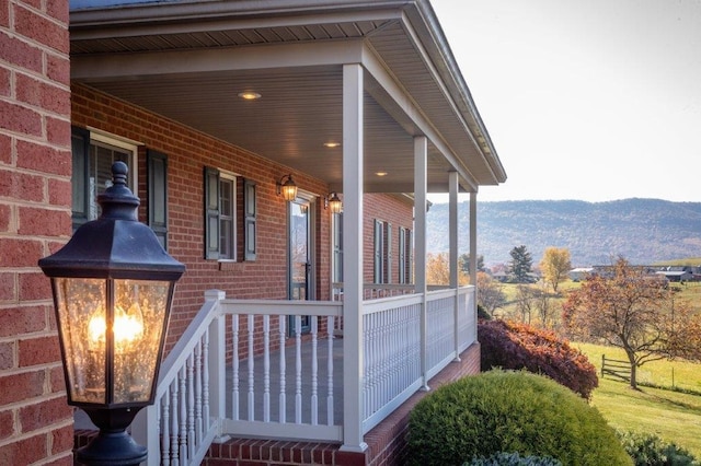 view of property exterior featuring a mountain view and covered porch