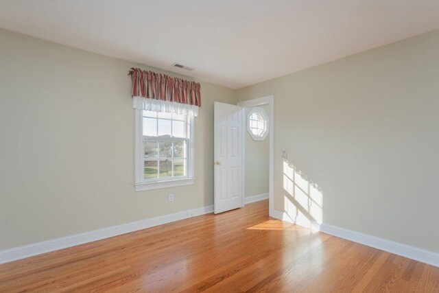 spare room featuring light hardwood / wood-style flooring