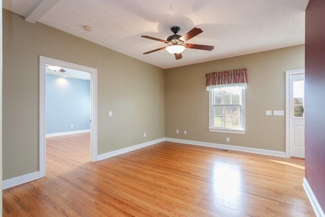 unfurnished room with ceiling fan and light wood-type flooring