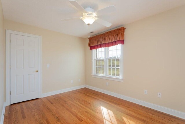 empty room featuring hardwood / wood-style floors and ceiling fan