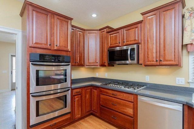 kitchen with stainless steel appliances and light wood-type flooring