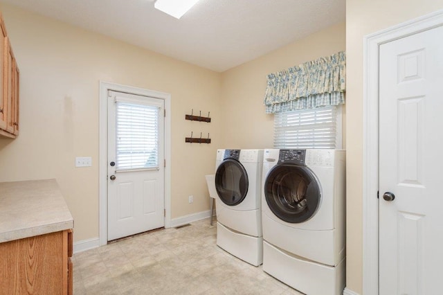 laundry area featuring cabinets and separate washer and dryer