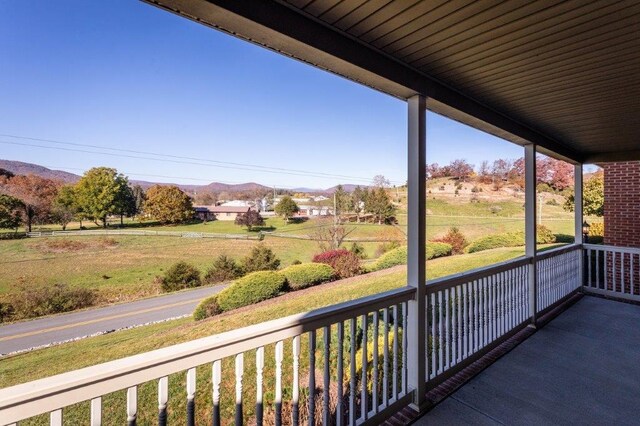 balcony featuring a mountain view and a rural view