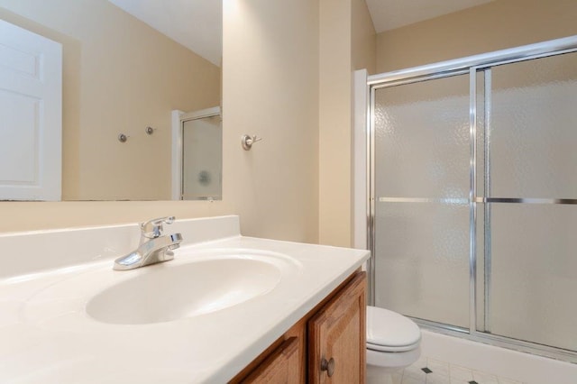 bathroom with toilet, vanity, and walk in shower