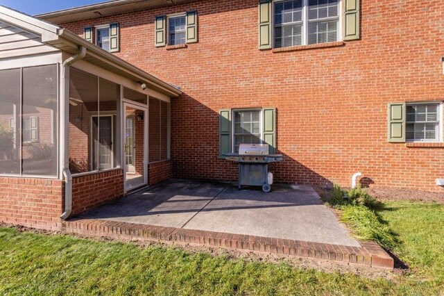 exterior space featuring a sunroom and a patio