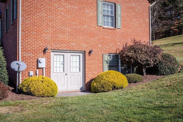 doorway to property featuring a lawn