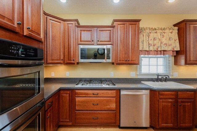 kitchen with sink and appliances with stainless steel finishes