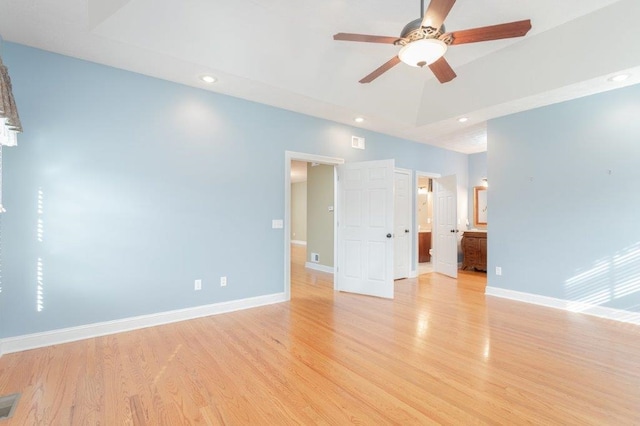 empty room with ceiling fan and light hardwood / wood-style flooring