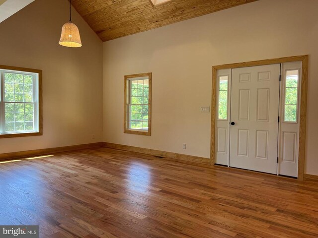 foyer with hardwood / wood-style floors, wood ceiling, and high vaulted ceiling