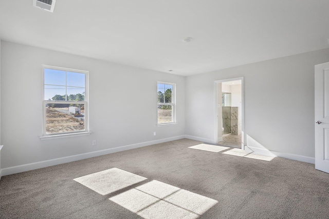 empty room with visible vents, baseboards, and carpet