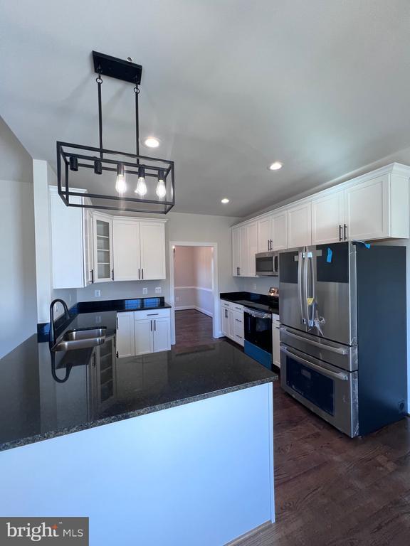 kitchen featuring white cabinetry, sink, and stainless steel appliances