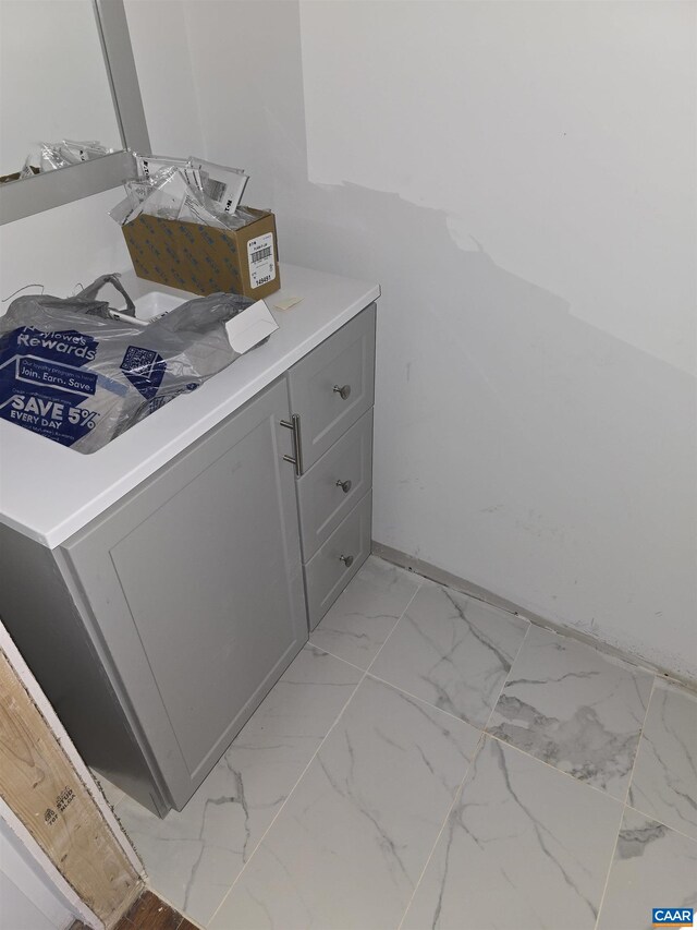 bathroom with marble finish floor