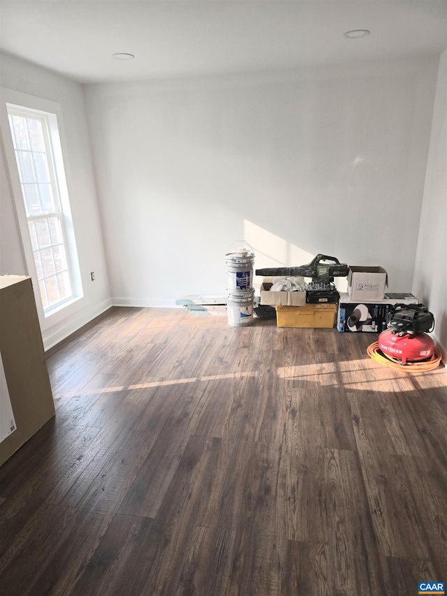 unfurnished room with dark hardwood / wood-style flooring