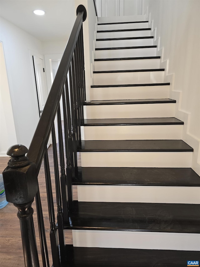 staircase with recessed lighting and wood finished floors