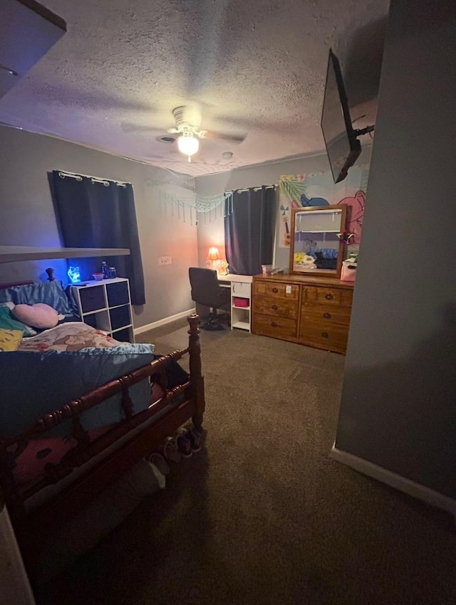 bedroom with ceiling fan, carpet, baseboards, and a textured ceiling