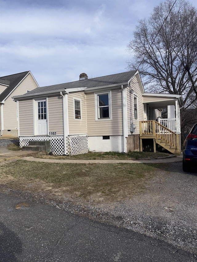 exterior space featuring crawl space and roof with shingles