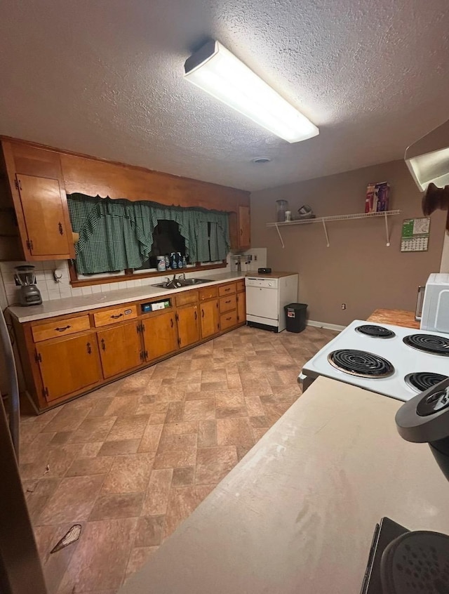 kitchen featuring open shelves, a sink, range with electric cooktop, light countertops, and brown cabinets