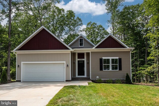 craftsman inspired home with a garage and a front yard