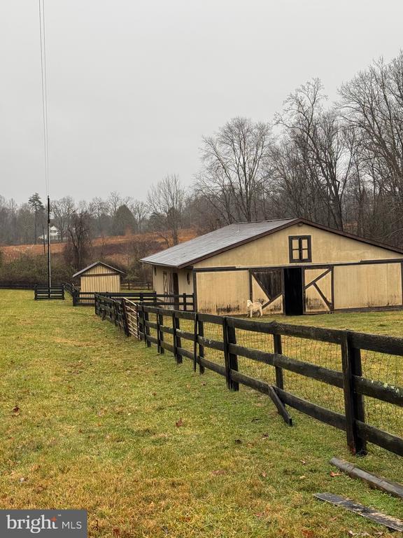 view of horse barn featuring a rural view