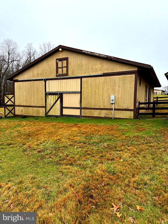 view of outbuilding featuring a yard