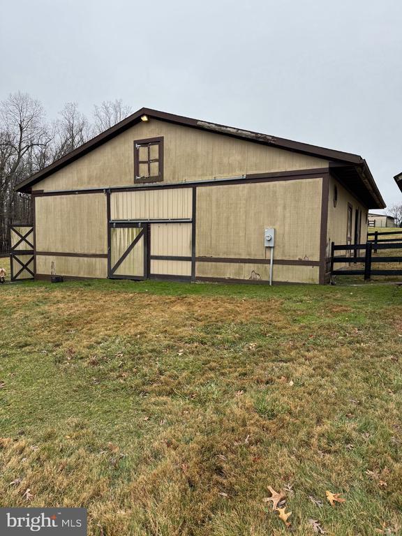 view of outbuilding with a lawn