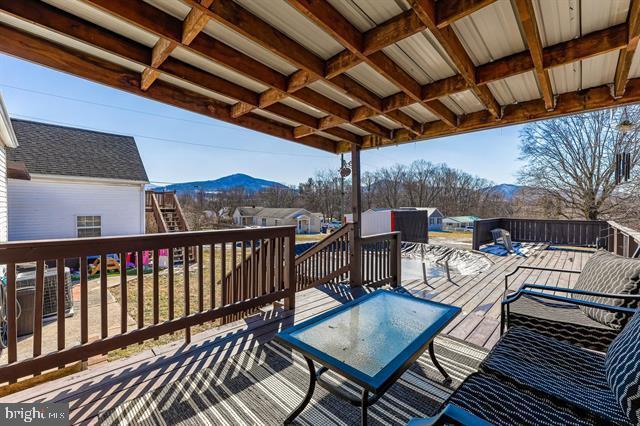 deck with central air condition unit and a mountain view