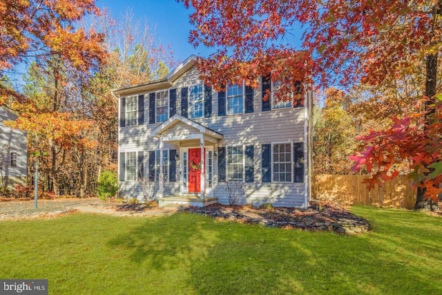 colonial inspired home featuring a front yard