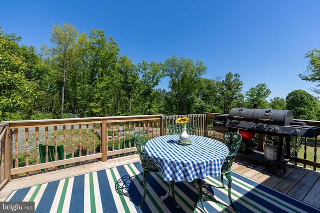 wooden terrace featuring outdoor dining area