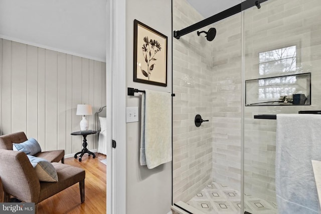 bathroom with wood-type flooring and an enclosed shower