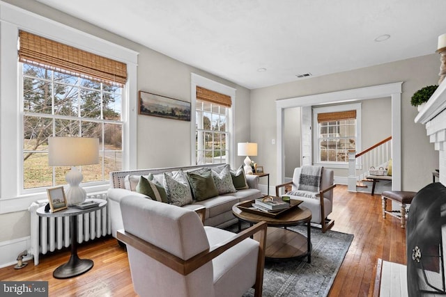 living room with hardwood / wood-style floors and radiator heating unit