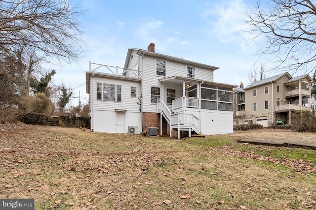 back of house with a yard, central AC, and a sunroom