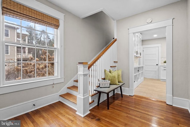 stairway featuring hardwood / wood-style flooring and a wealth of natural light