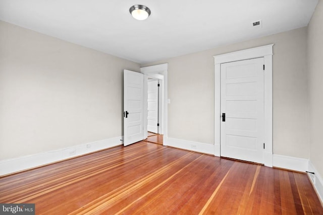 spare room featuring wood-type flooring