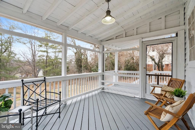 sunroom featuring plenty of natural light, vaulted ceiling with beams, and wooden ceiling