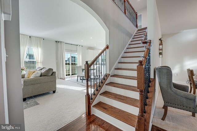 stairs featuring hardwood / wood-style flooring