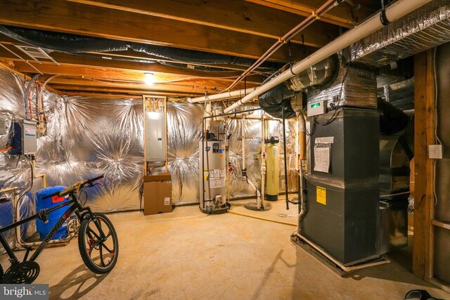 basement featuring gas water heater, heating unit, and electric panel