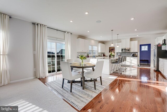 dining area with light hardwood / wood-style floors