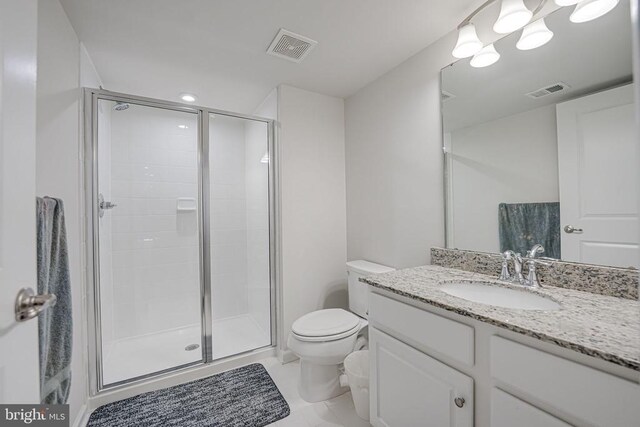 bathroom with tile patterned floors, vanity, toilet, and an enclosed shower