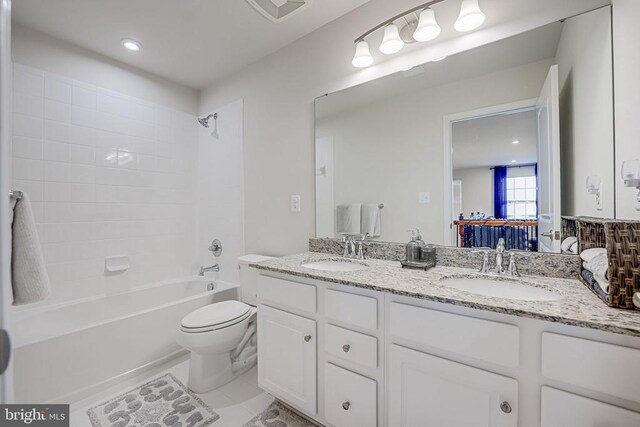 full bathroom featuring tile patterned flooring, vanity, tub / shower combination, and toilet