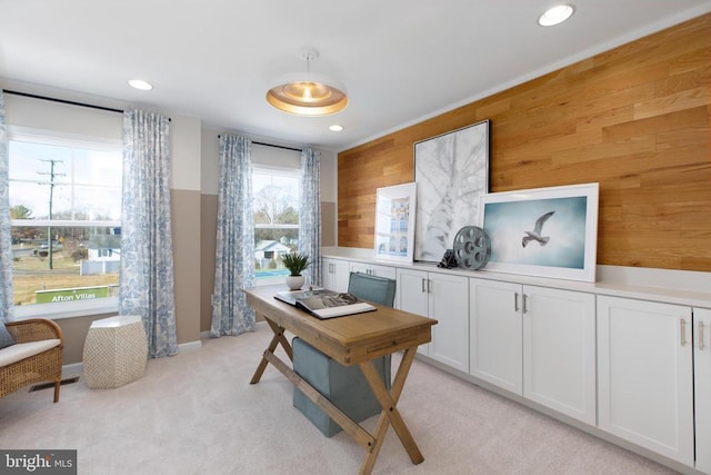 carpeted home office with wood walls