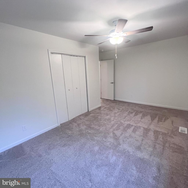 unfurnished bedroom featuring carpet floors, ceiling fan, and a closet