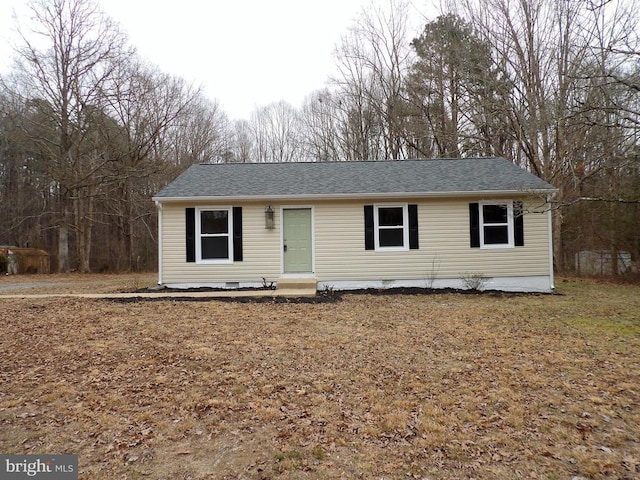 ranch-style house with entry steps, a shingled roof, and crawl space