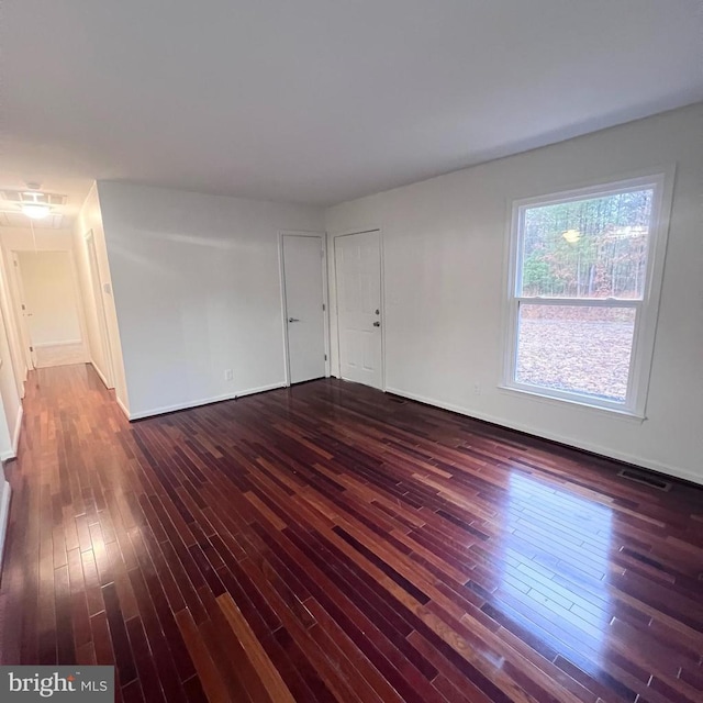 spare room featuring dark hardwood / wood-style flooring