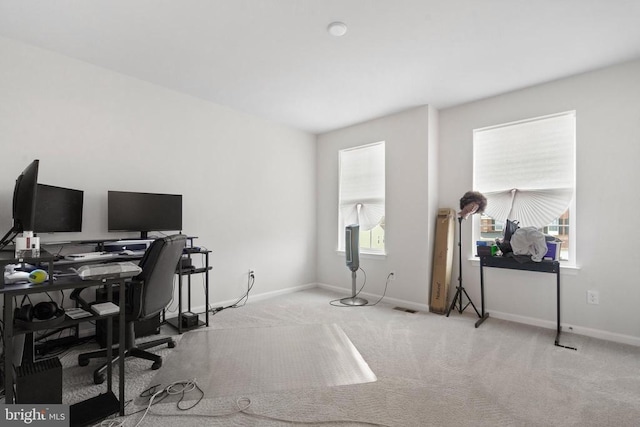 carpeted office space featuring baseboards