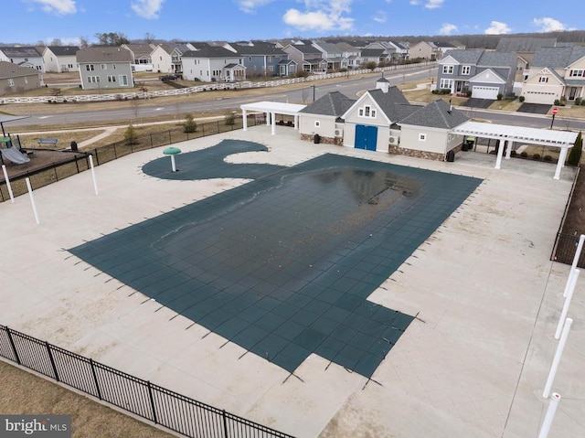 view of pool featuring fence and a residential view