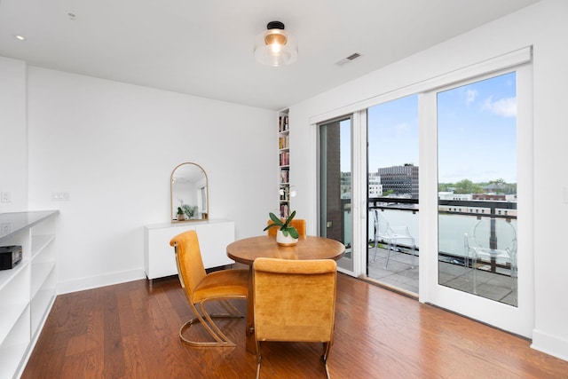 dining room featuring wood finished floors and visible vents